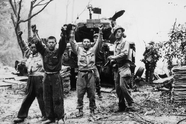 A U.S. Marine with North Korean prisoners of war in Korea in 1953. (U.S. Marine Corps photo) Korean War Prisoners